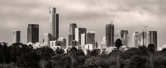 Panoramic view of buildings in city against sky