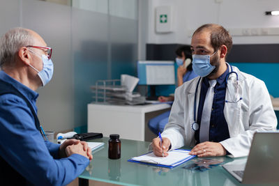 Doctor examining patient in office