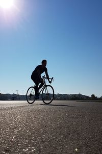 Man riding bicycle against clear sky