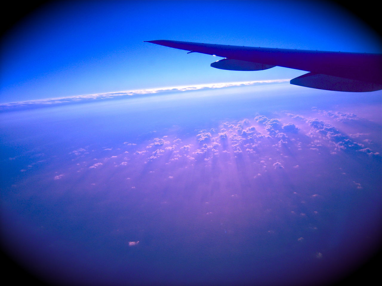 AERIAL VIEW OF AIRPLANE WING ABOVE SEA