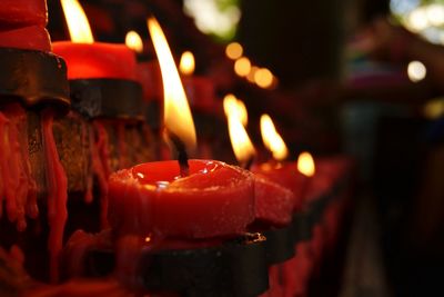 Close-up of burning candles on cake