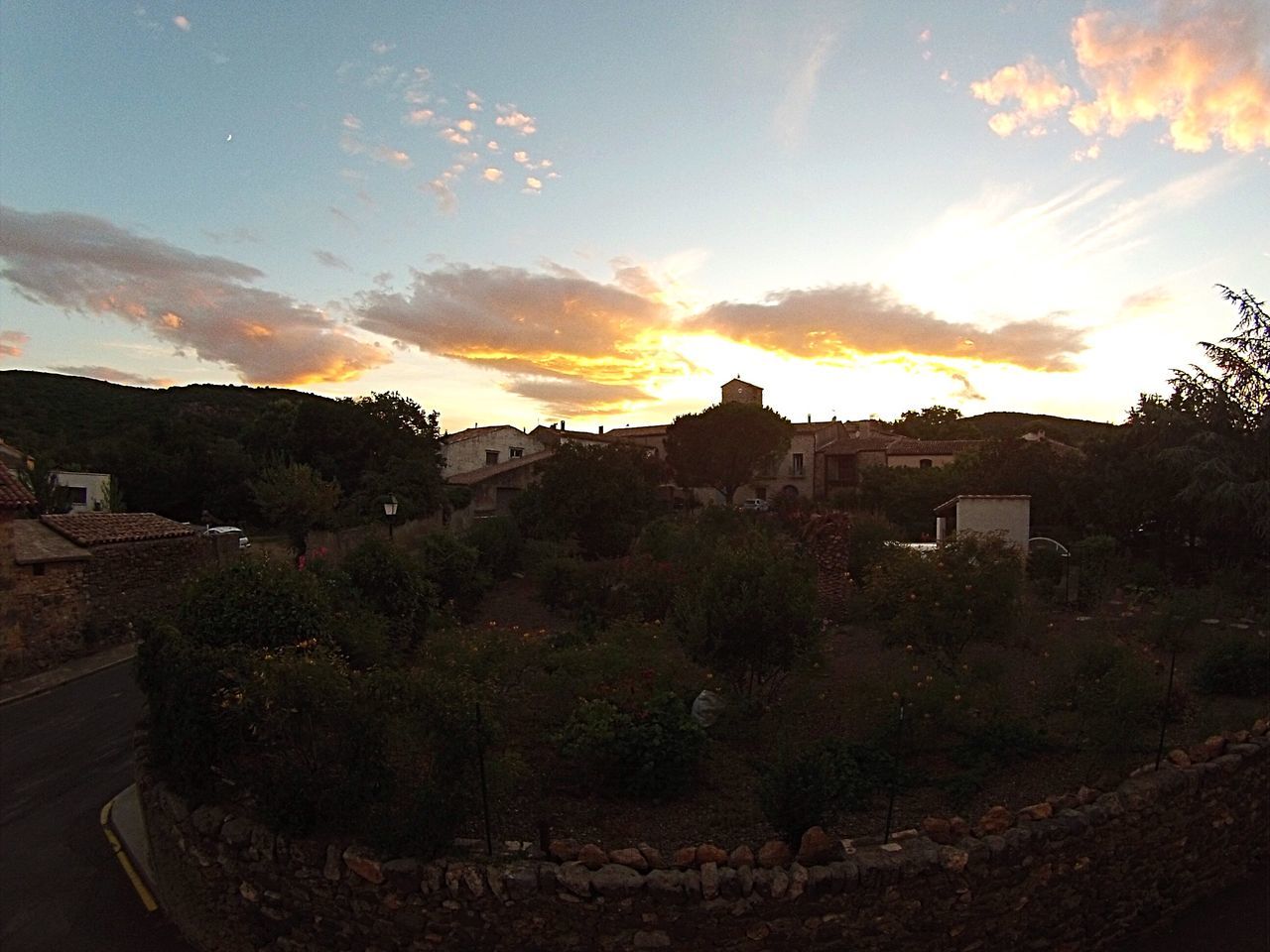 building exterior, architecture, built structure, sunset, house, sky, residential structure, residential building, tree, cloud - sky, sunlight, residential district, town, orange color, sun, city, nature, high angle view, outdoors, no people