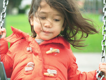 Girl enjoying swing at playground