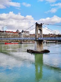 Bridge over river with city in background
