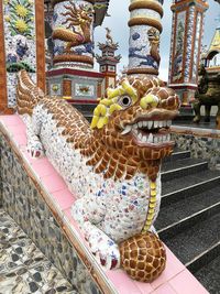 Close-up of statue against temple building