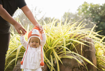 Mother and daughter against plants