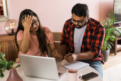 Young woman using laptop at home