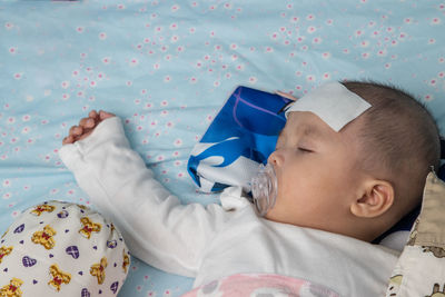 Close-up of baby sleeping on bed