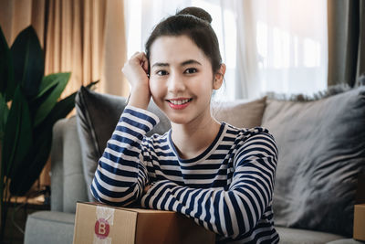 Portrait of young woman reading book