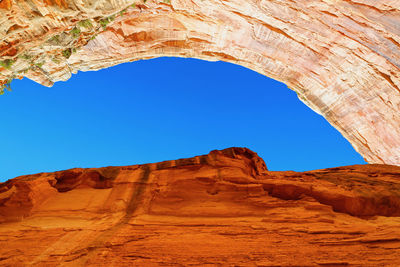 Low angle view of rock formations against blue sky