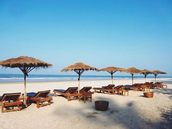 View of sandy beach against blue sky