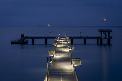 View of pier over sea against blue sky