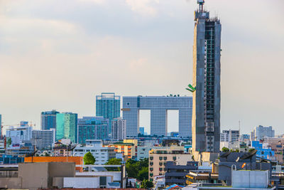 City skyline against cloudy sky