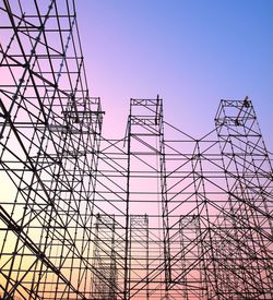 Low angle view of electricity pylon against clear sky