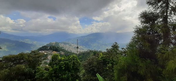 Panoramic view of trees and mountains against sky