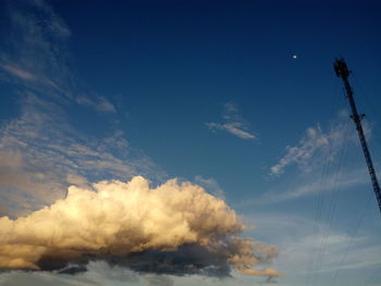 Low angle view of telephone pole against blue sky