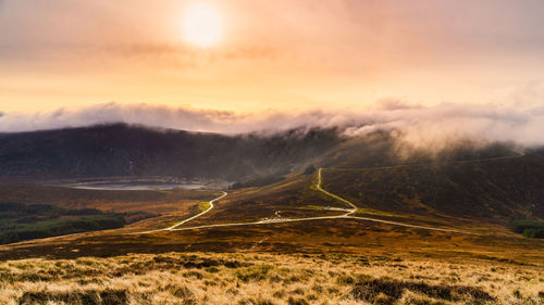 Scenic view of landscape against sky during sunset