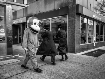 Men standing on sidewalk in city