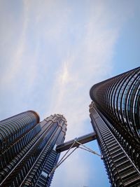 Low angle view of modern building against cloudy sky