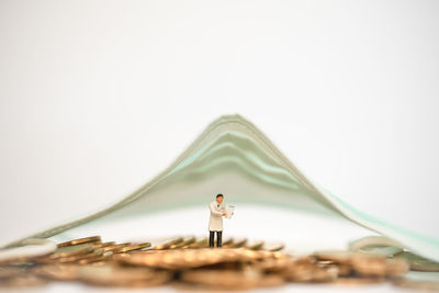 Close-up of figurine against white background