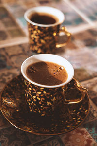 Close-up of coffee cups on table