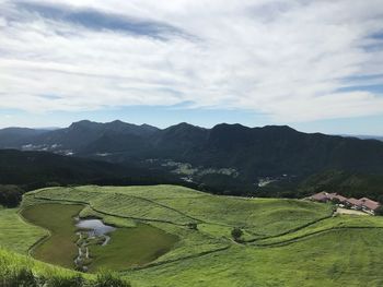 Scenic view of agricultural field against sky