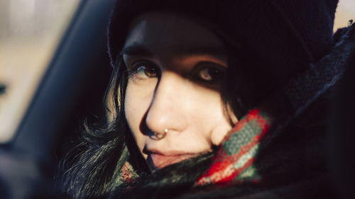 Close-up portrait of woman in car