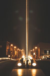 Illuminated road in city at night