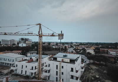 High angle view of buildings in town against sky