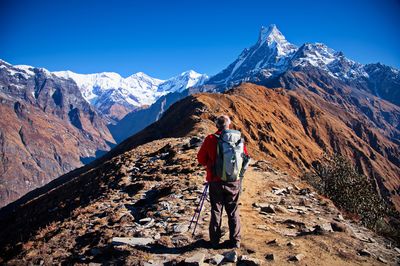 Senior man standing on the ridge in himalayas mountains, nepal