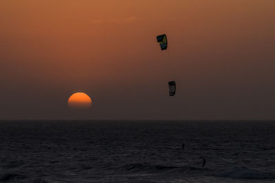 Scenic view of sea against orange sky