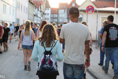 Rear view of people walking in city
