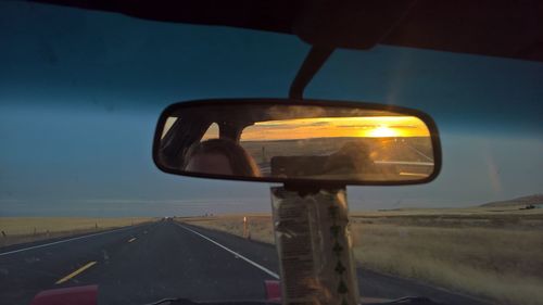 Close-up of car on road against sky