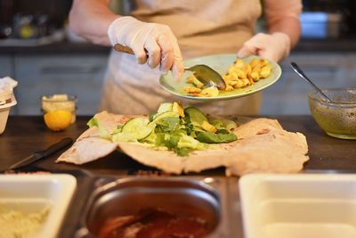 Midsection of man preparing food in kitchen