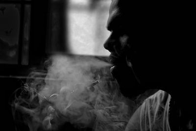 Side view of man smoking cigarette