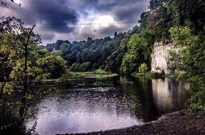 Scenic view of lake against cloudy sky