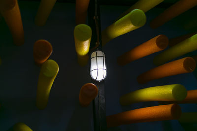 Low angle view of illuminated lights hanging from ceiling