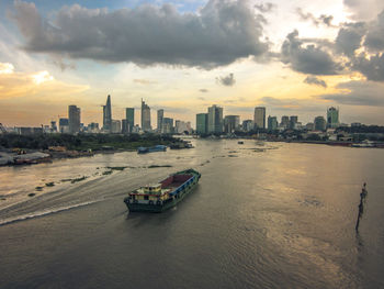 View of boats in sea against cloudy sky