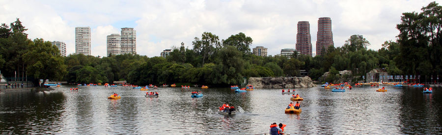 Panoramic view of city by river against sky