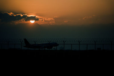 Silhouette ship against sky during sunset