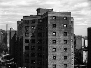 Low angle view of building against cloudy sky