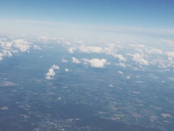 Aerial view of landscape against blue sky