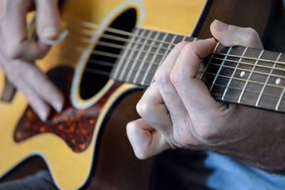 Close-up of man playing guitar