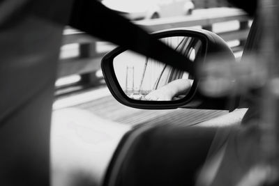 Reflection of man on side-view mirror