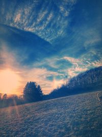 Scenic view of snow field against sky during sunset