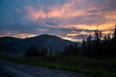 Scenic view of mountains against sky at sunset