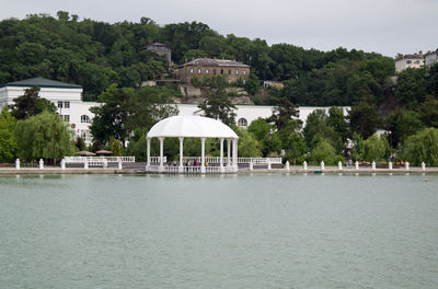 Built structure on lake against buildings