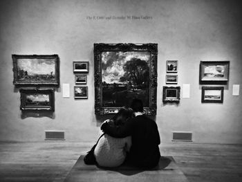 Full length of woman sitting on bench