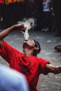 Close-up of man performing fire stunt