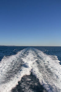 Scenic view of sea against clear blue sky